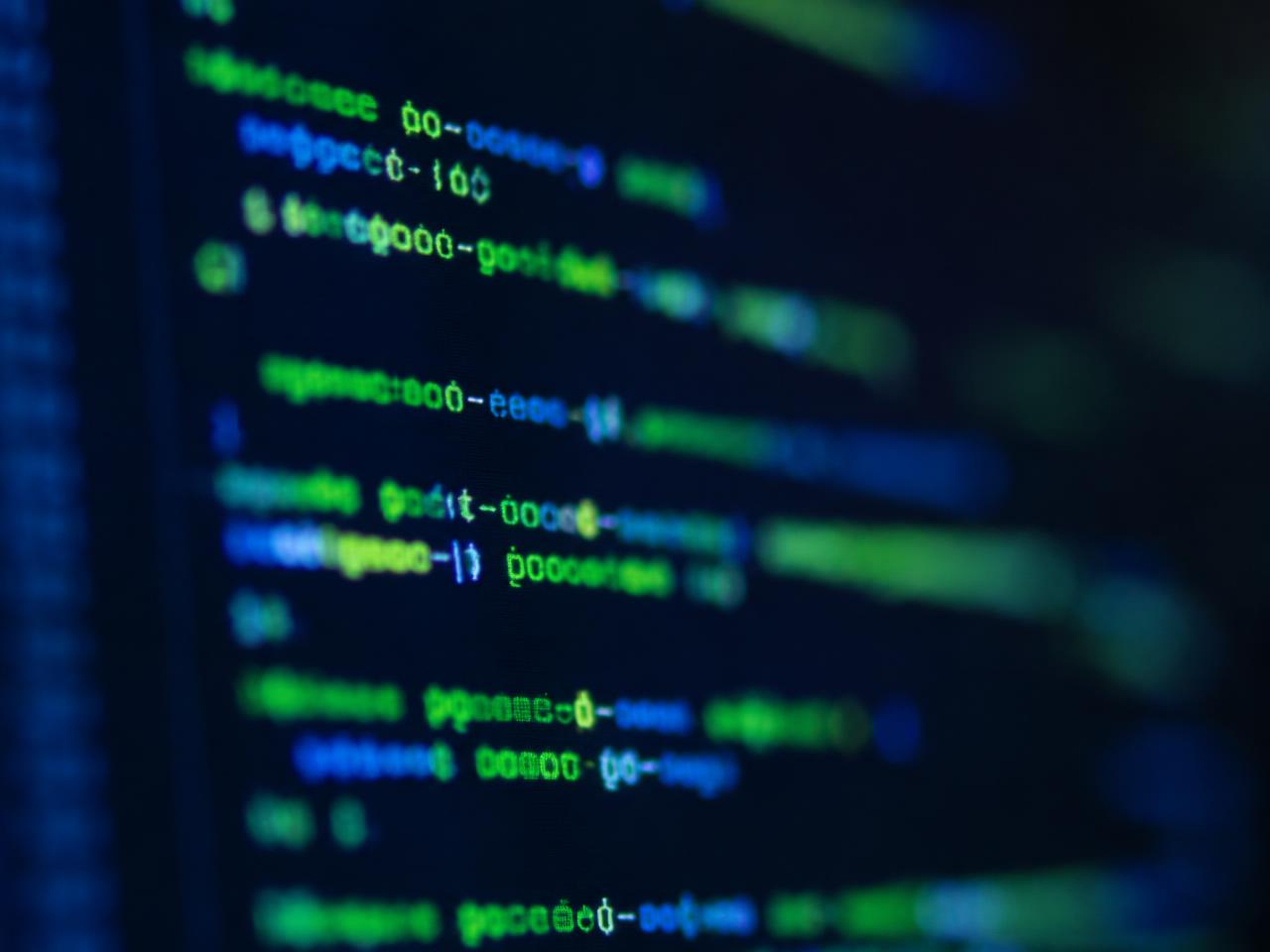 Close-up of source code displayed on a dark editor screen